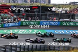 Sergio Perez (MEX) Red Bull Racing RB20 leads Pierre Gasly (FRA) Alpine F1 Team A524 at the start of the race. 25.08.2024. Formula 1 World Championship, Rd 15, Dutch Grand Prix, Zandvoort, Netherlands, Race Day.