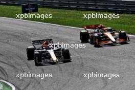 Max Verstappen (NLD) Red Bull Racing RB20 and Lando Norris (GBR) McLaren MCL38 battle for position. 25.08.2024. Formula 1 World Championship, Rd 15, Dutch Grand Prix, Zandvoort, Netherlands, Race Day.