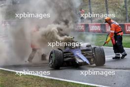 Marshals put out the fire in the Williams Racing FW46 of Logan Sargeant (USA) Williams Racing after he crashed in the third practice session.