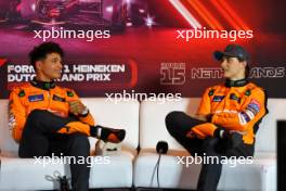 (L to R): Lando Norris (GBR) McLaren and Oscar Piastri (AUS) McLaren in the post qualifying FIA Press Conference. 24.08.2024. Formula 1 World Championship, Rd 15, Dutch Grand Prix, Zandvoort, Netherlands, Qualifying Day.