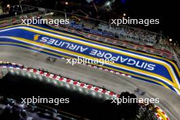 Kevin Magnussen (DEN) Haas VF-24 and Yuki Tsunoda (JPN) RB VCARB 01. 20.09.2024. Formula 1 World Championship, Rd 18, Singapore Grand Prix, Marina Bay Street Circuit, Singapore, Practice Day.