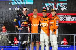 The podium (L to R): Max Verstappen (NLD) Red Bull Racing, second; Paul Barnes (GBR) McLaren Director of Support and Logistics celebrates on the podium; Lando Norris (GBR) McLaren, race winner; Oscar Piastri (AUS) McLaren, third. 22.09.2024. Formula 1 World Championship, Rd 18, Singapore Grand Prix, Marina Bay Street Circuit, Singapore, Race Day.