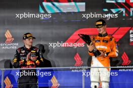 Race winner Lando Norris (GBR) McLaren celebrates on the podium with second placed Max Verstappen (NLD) Red Bull Racing (Left). 22.09.2024. Formula 1 World Championship, Rd 18, Singapore Grand Prix, Marina Bay Street Circuit, Singapore, Race Day.