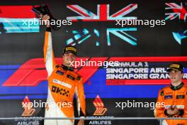 (L to R): Race winner Lando Norris (GBR) McLaren celebrates on the podium with third placed team mate Oscar Piastri (AUS) McLaren. 22.09.2024. Formula 1 World Championship, Rd 18, Singapore Grand Prix, Marina Bay Street Circuit, Singapore, Race Day.