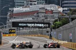 Sergio Perez (MEX) Red Bull Racing RB20 and Charles Leclerc (MON) Ferrari SF-24. 21.09.2024. Formula 1 World Championship, Rd 18, Singapore Grand Prix, Marina Bay Street Circuit, Singapore, Qualifying Day.