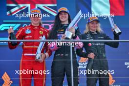 The podium (L to R): Maya Weug (NLD) Prema, second; Abbi Pulling (GBR) Rodin Motorsport, race winner; Doriane Pin (FRA) Prema Racing, third. 22.09.2024. FIA Formula Academy, Rd 5, Race 2, Marina Bay Street Circuit, Singapore, Sunday.