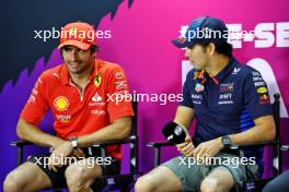 (L to R): Carlos Sainz Jr (ESP) Ferrari and Sergio Perez (MEX) Red Bull Racing in the FIA Press Conference. 21.02.2024. Formula 1 Testing, Sakhir, Bahrain, Day One.
