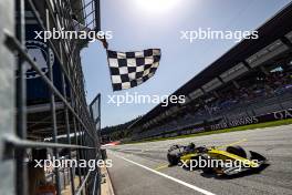 Race winner Gabriel Bortoleto (BRA) Invicta Racing takes the chequered flag at the end of the race. 30.06.2024. FIA Formula 2 Championship, Rd 7, Feature Race, Spielberg, Austria, Sunday.